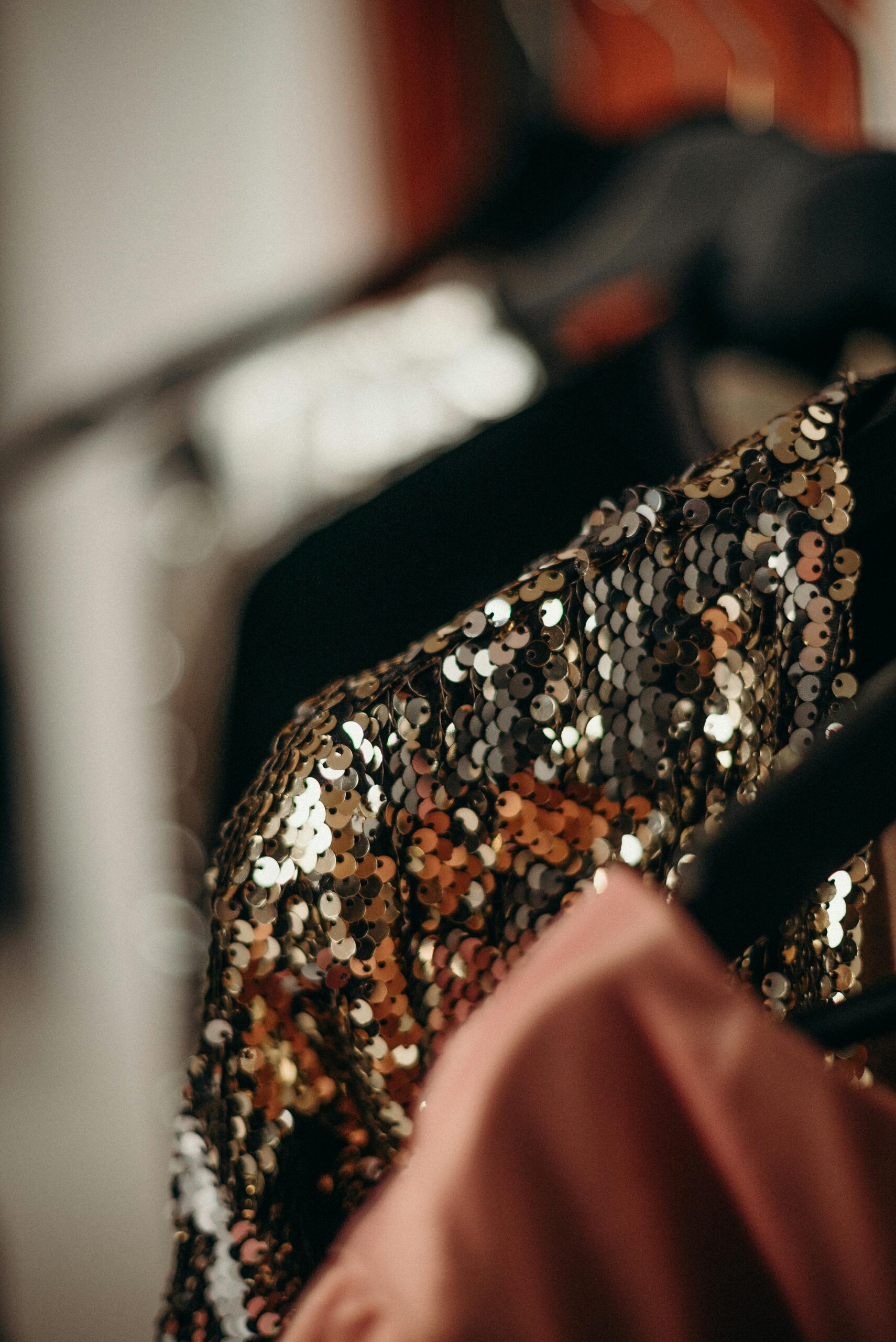 Artistic shot of fashion clothes with sequins and blurred background, highlighting details.